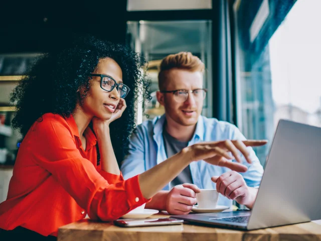 Man and woman looking at a laptop